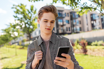 Image showing teenage student boy with phone and bag in city