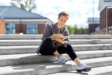 Image showing young man with notebook or sketchbook in city