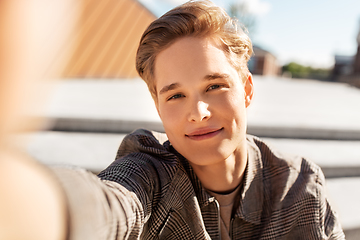 Image showing young man or teenage boy taking selfie in city