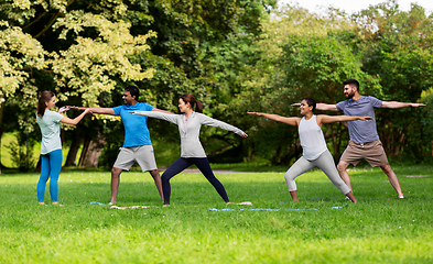 Image showing group of people doing yoga at summer park