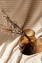 Image showing decorative dried flowers in brown glass vase