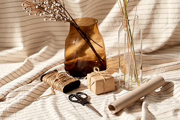 Image showing gift wrapping, dried flowers in vases on drapery