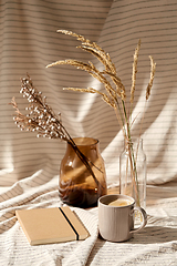 Image showing cup of coffee, diary and dried flowers in vases