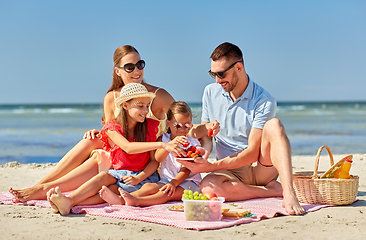 Image showing happy family having picnic on summer beach