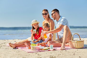 Image showing happy family having picnic on summer beach