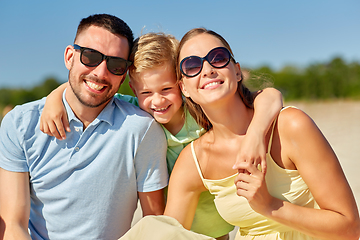 Image showing happy family hugging on summer beach