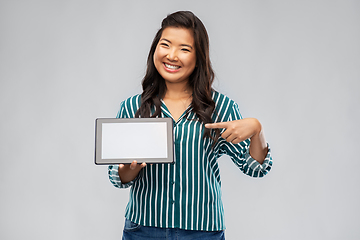 Image showing happy asian woman using tablet computer