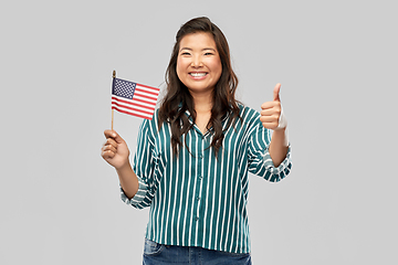 Image showing asian woman with flag of america showing thumbs up