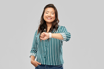 Image showing happy smiling woman with smart watch