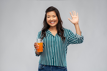 Image showing asian woman with juice in plastic cup with straw