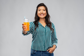 Image showing asian woman with juice in plastic cup with straw