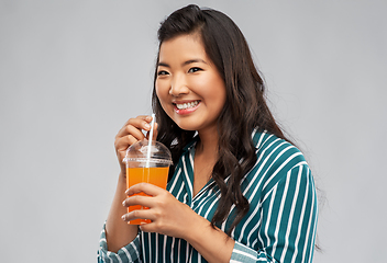 Image showing asian woman with juice in plastic cup with straw