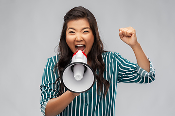 Image showing angry young asian woman speaking to megaphone