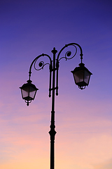 Image showing Beautiful vintage street lamp against a bright sunrise sky