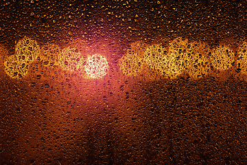 Image showing Rain on a window with big city bokeh lights