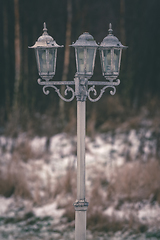 Image showing Vintage outdoor lamp with three lanterns