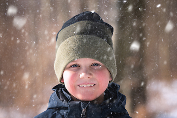 Image showing Young boy in the snow with a knitted hat