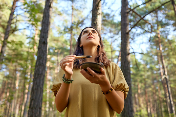 Image showing woman or witch performing magic ritual in forest