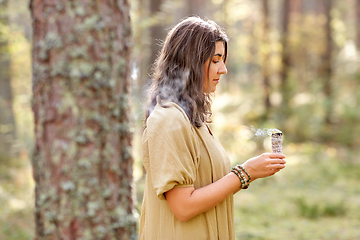 Image showing woman or witch performing magic ritual in forest