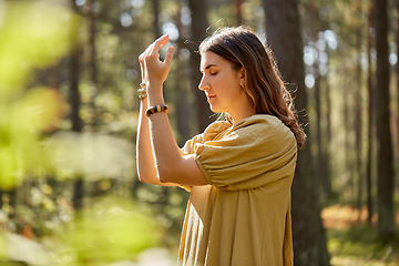 Image showing woman or witch performing magic ritual in forest