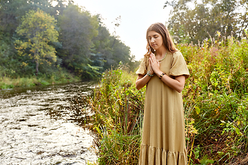 Image showing woman or witch performing magic ritual on river