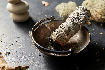 Image showing smoking white sage in cup and other magic staff