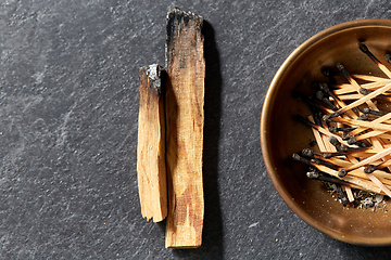 Image showing palo santo sticks and cup with burnt matches