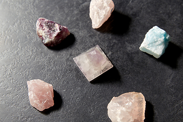 Image showing quartz crystal pyramid and gem stones on slate