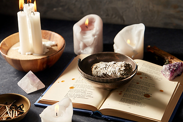 Image showing magic book, sage, burning candles and ritual staff