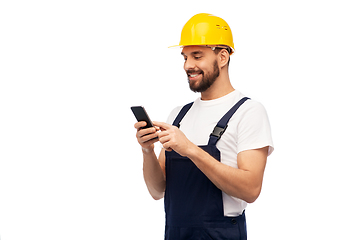 Image showing happy male worker or builder with smartphone