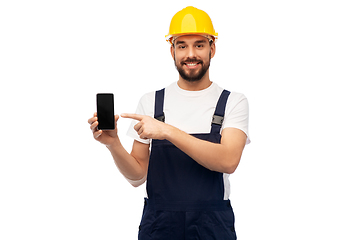 Image showing happy male worker or builder showing smartphone