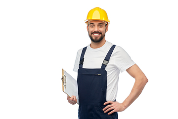 Image showing happy worker or builder in helmet with clipboard