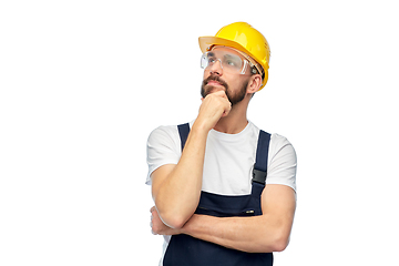 Image showing thinking male worker or builder with crossed arms