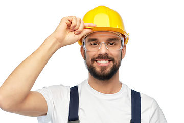 Image showing happy male worker or builder in helmet and overall