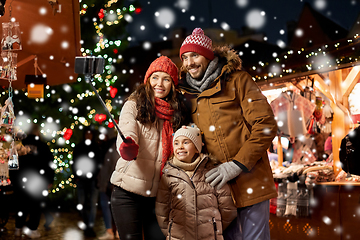 Image showing happy family taking selfie at christmas market