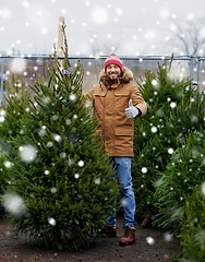 Image showing happy man buying christmas tree at market