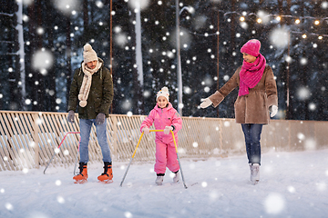 Image showing happy family at outdoor skating rink in winter