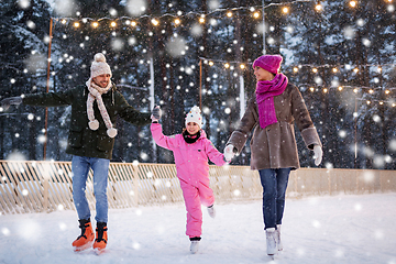 Image showing happy family at outdoor skating rink in winter