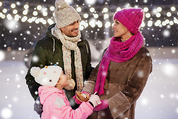 Image showing happy family eating pancakes on skating rink