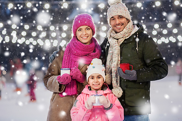 Image showing happy family drinking hot tea on skating rink