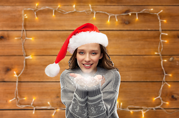 Image showing woman in christmas sweater holding magic dust