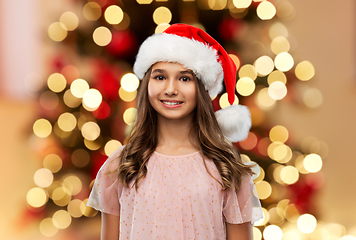 Image showing happy teenage girl in santa hat on christmas