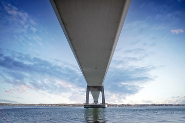 Image showing Under a large bridge over the sea