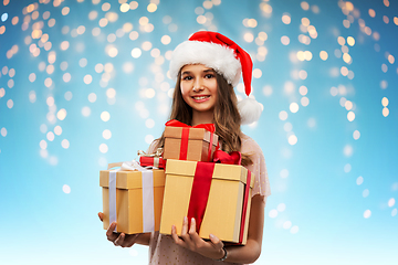 Image showing teenage girl in santa hat with christmas gift