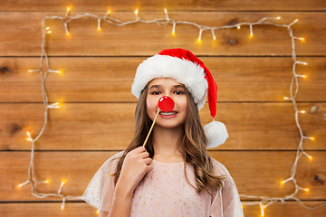 Image showing happy teenage girl in santa hat on christmas