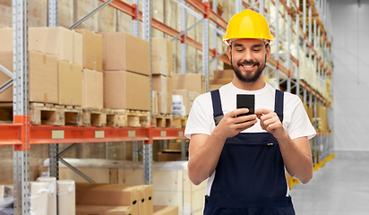 Image showing happy male worker with smartphone at warehouse