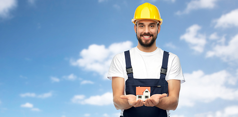 Image showing happy male builder holding model of living house