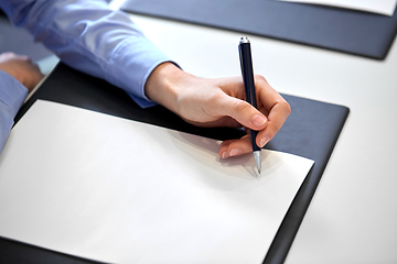 Image showing close up of businesswoman with paper at office