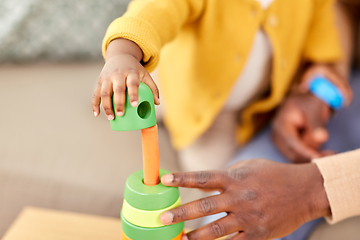 Image showing close up of baby playing toy blocks at home