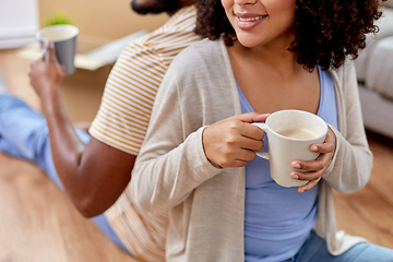 Image showing happy couple drinking coffee moving to new home